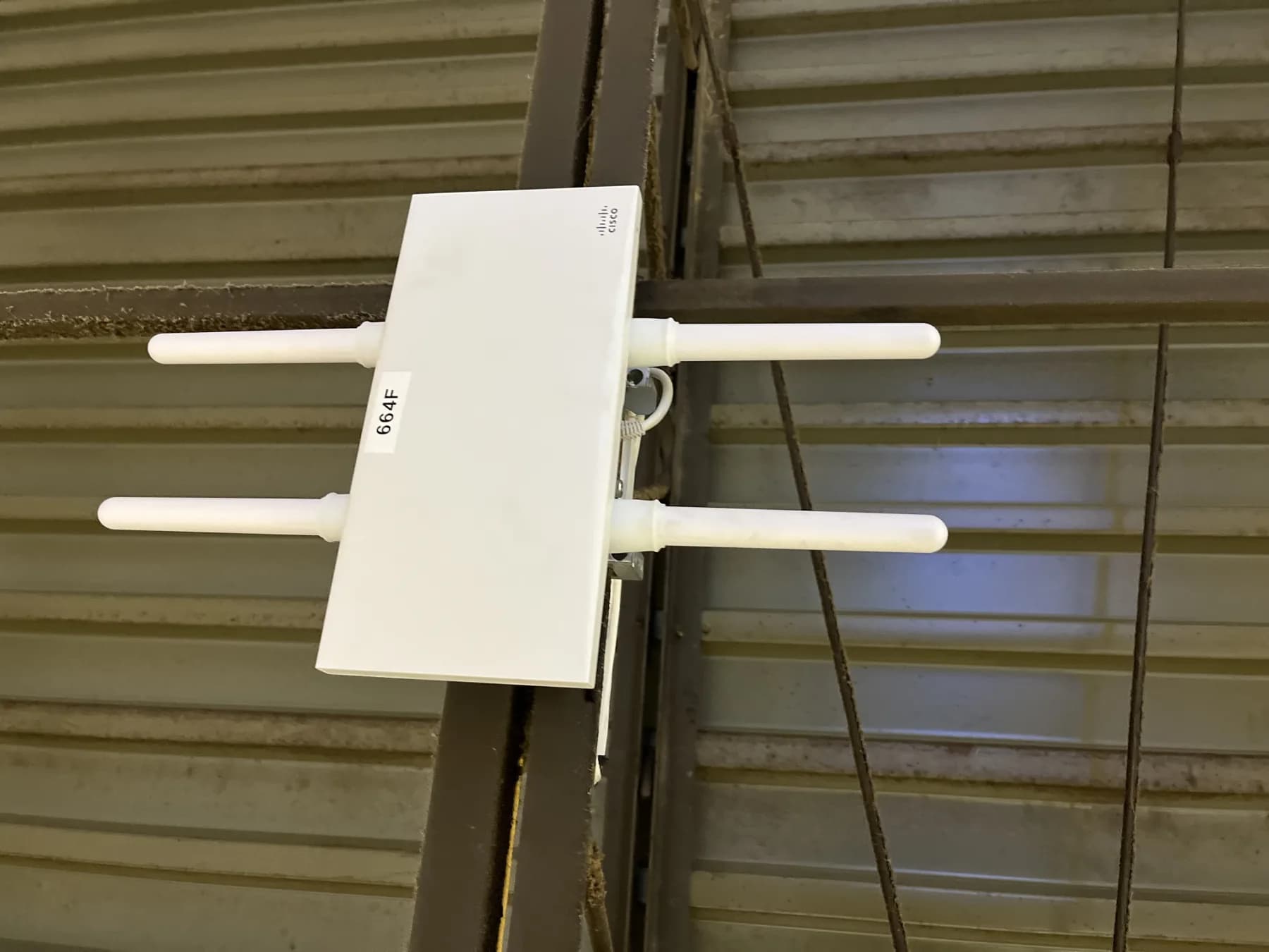 Commercial wireless access point mounted on a warehouse wall